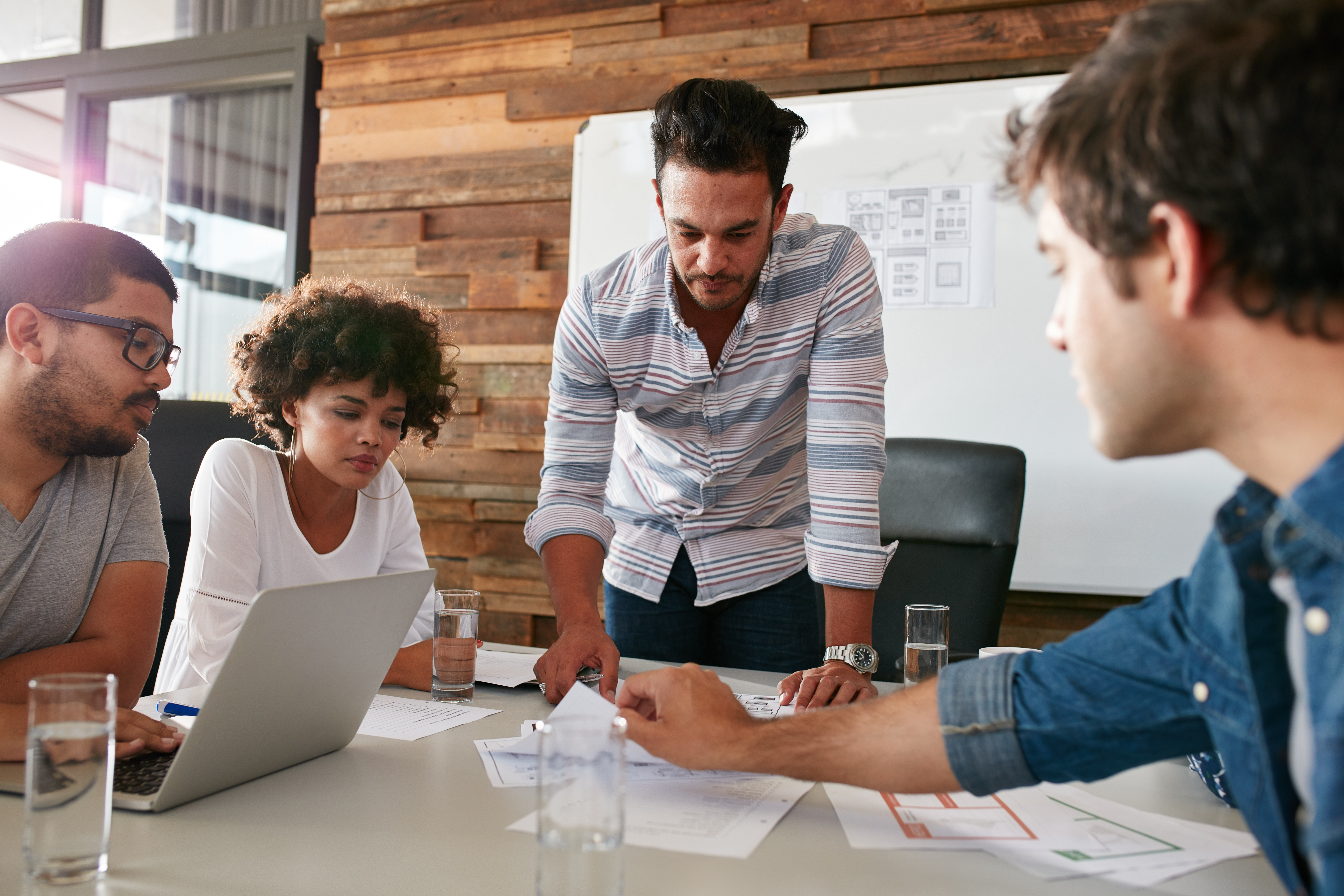 image of a team in a meeting room discussing potential options and outcomes